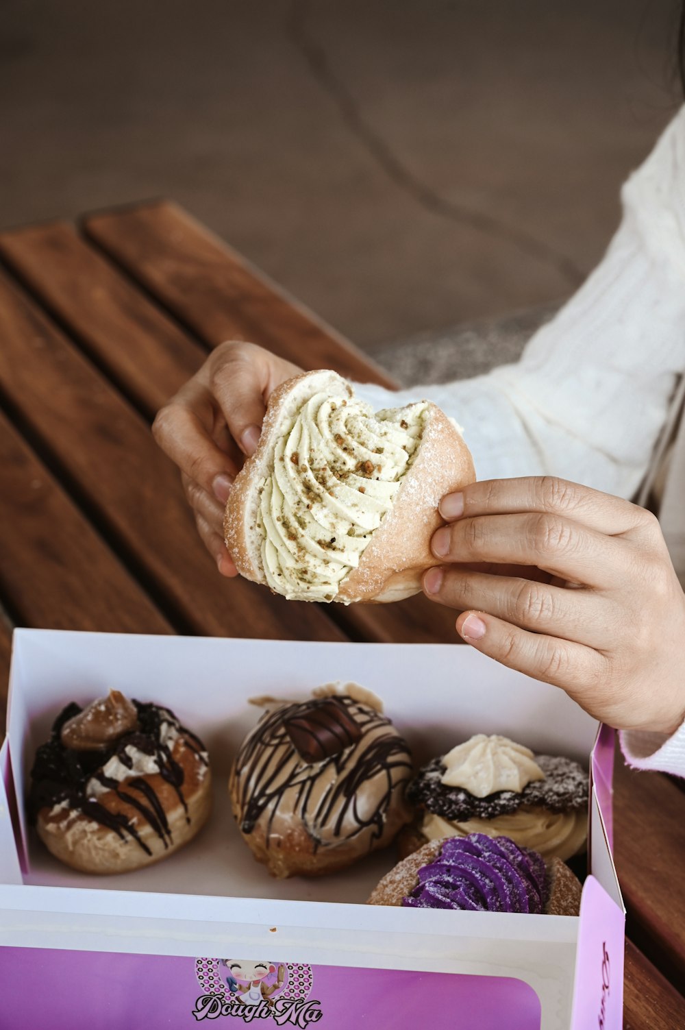 person holding brown and white ice cream cone