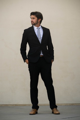 man in black suit standing