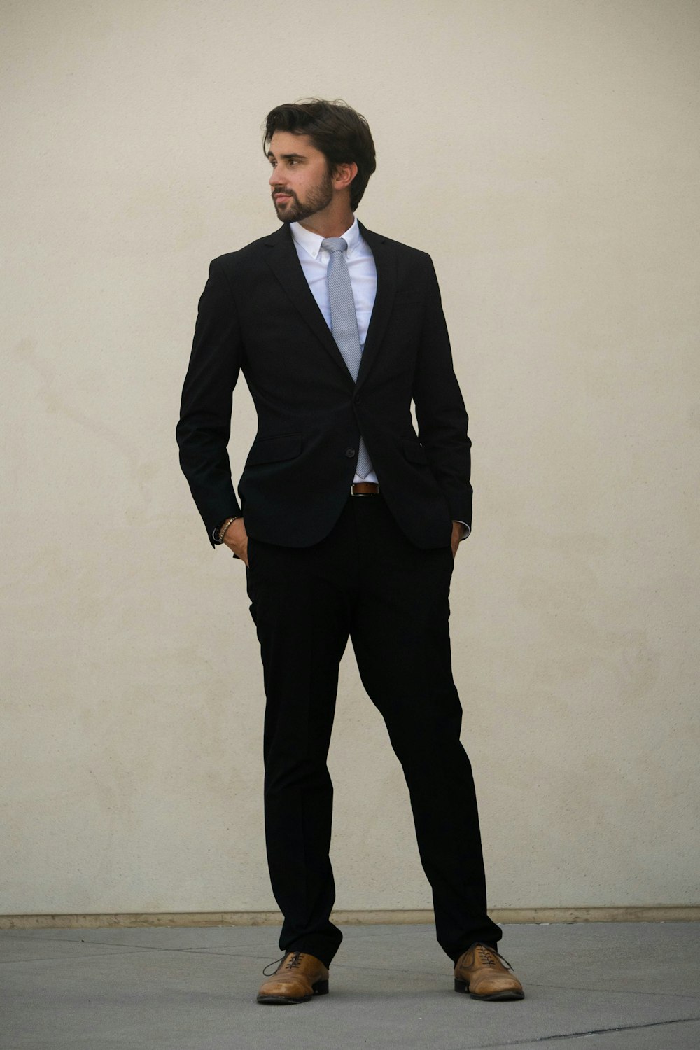man in black suit standing