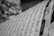 Black and white photo of a page with Arabic script, showing neatly written characters in rows with diacritical marks.