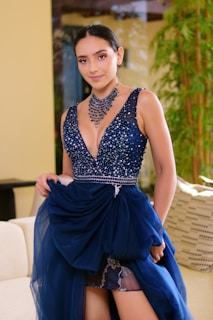 woman in blue and white sleeveless dress sitting on white couch
