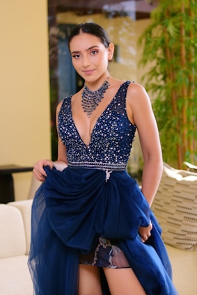 woman in blue and white sleeveless dress sitting on white couch