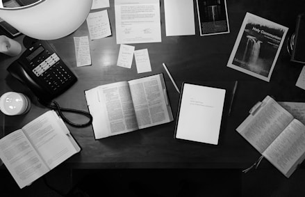 A serene office space with a Bible and business plans laid out, symbolizing faith-driven strategy.