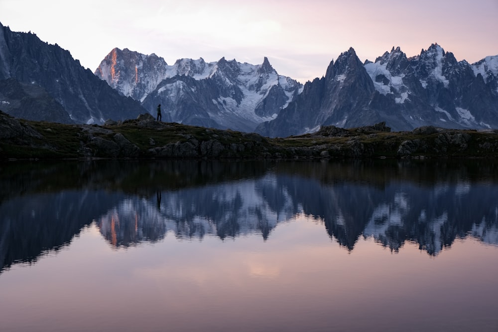 brown and white mountains near lake during daytime