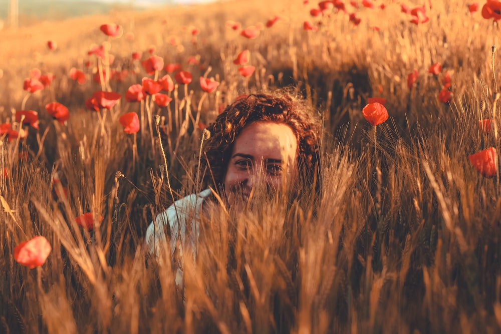 woman in blue and white scarf on brown grass field during daytime