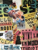 A vibrant and eclectic collage composed of various torn and layered posters and clippings. The collage includes images of a horse, a person holding a llama with blue glasses, and an open book. There are numerous texts and advertisements featuring different fonts, colors, and sizes, creating a chaotic and dynamic visual. The background consists of mixed colors like yellow, green, pink, and black, with fragments of paper and bold letters scattered throughout.