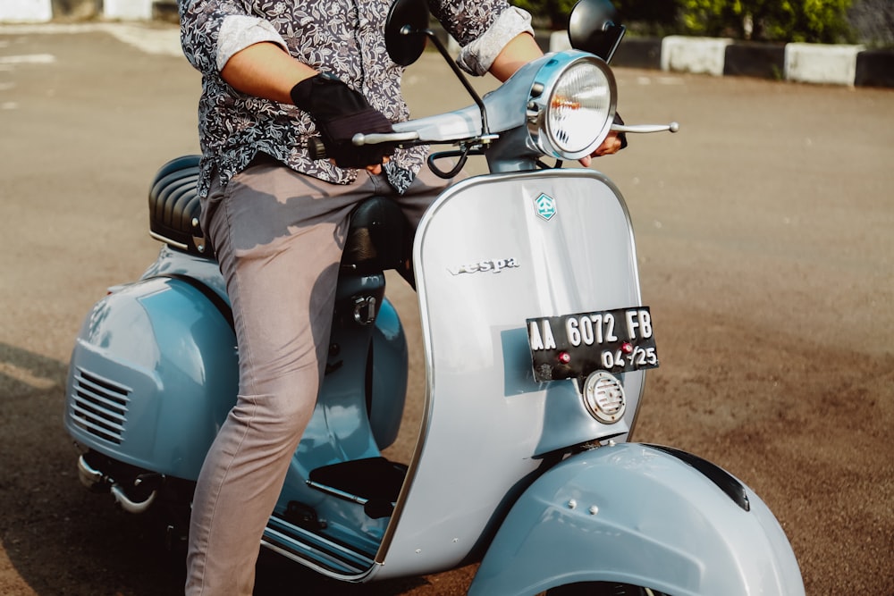 woman in blue and white floral long sleeve shirt and blue leggings riding on white and