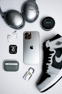 black iphone 4 beside silver and black camera