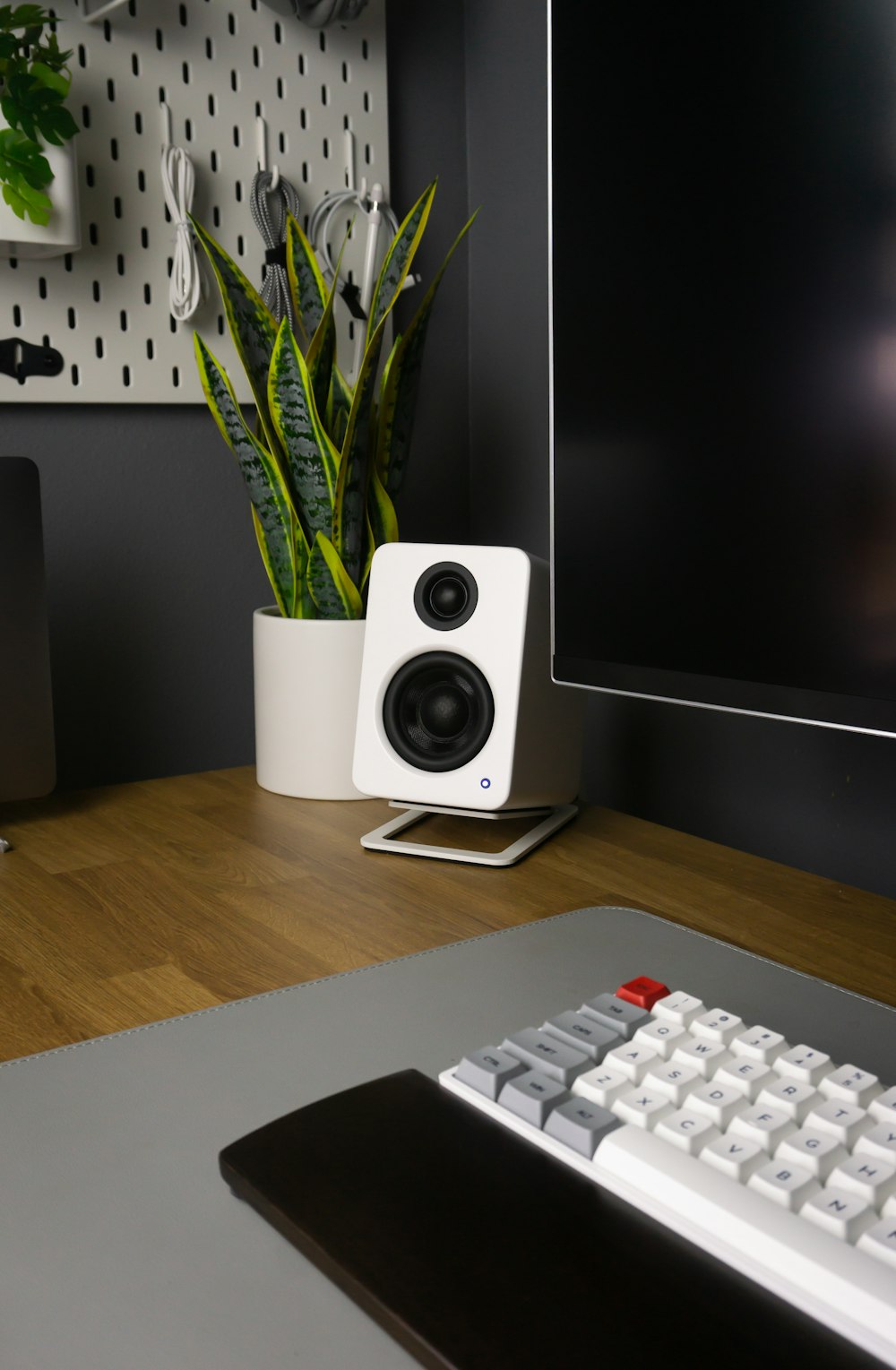 white computer keyboard on brown wooden desk