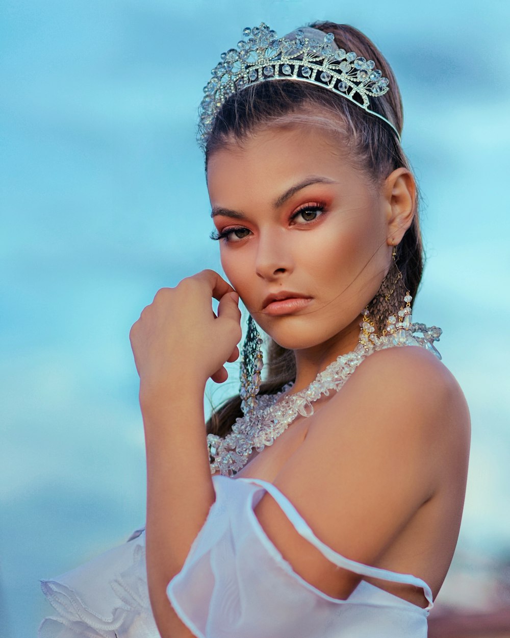 woman in white tank top wearing silver tiara