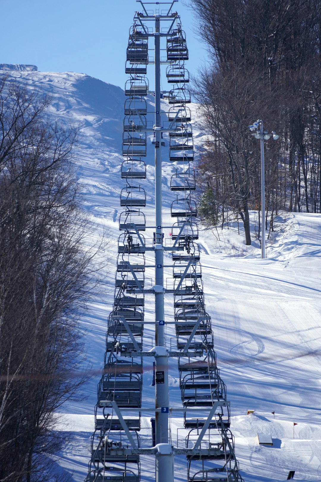 gray metal tower on snow covered ground during daytime