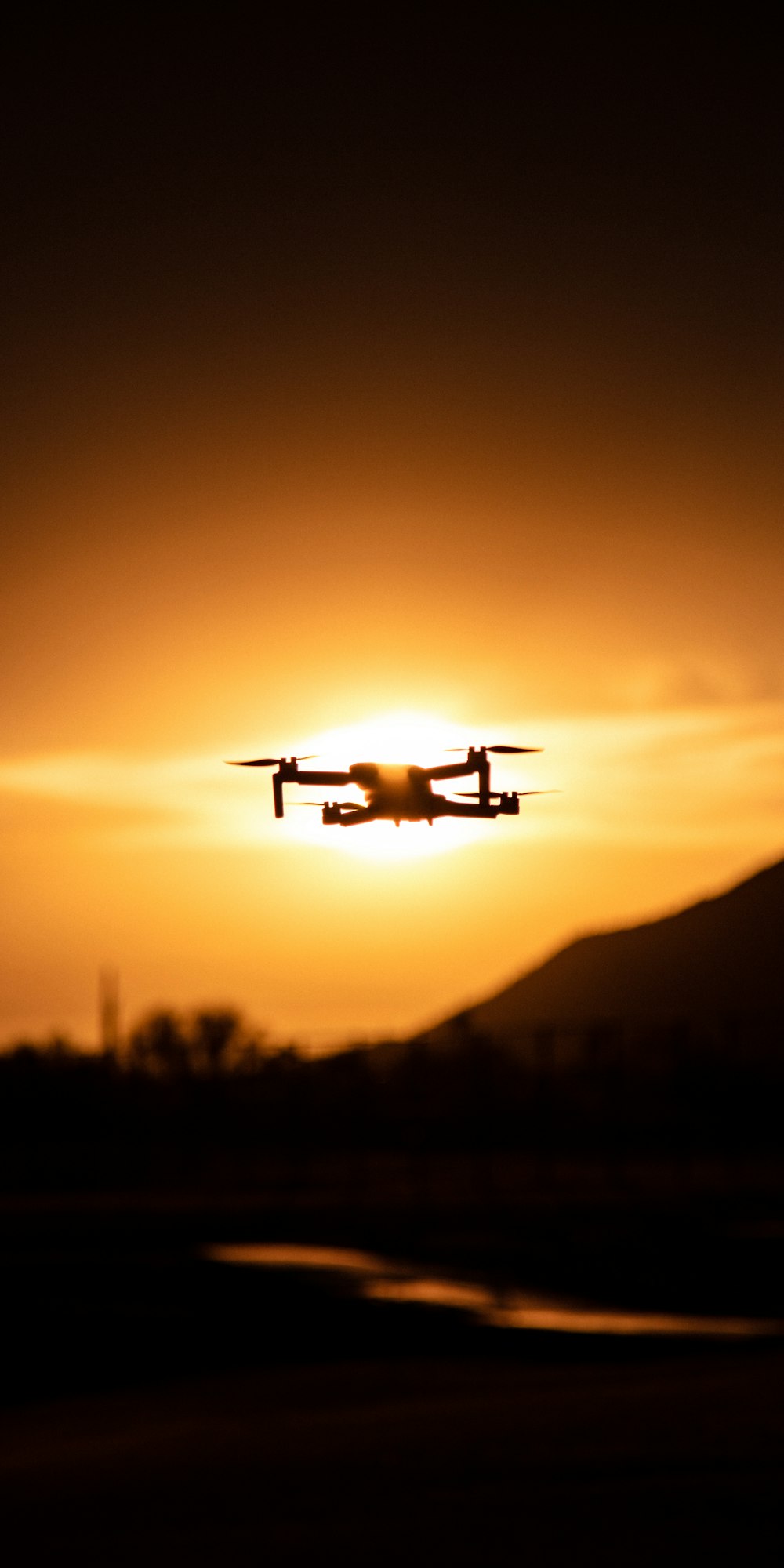 white drone flying during sunset