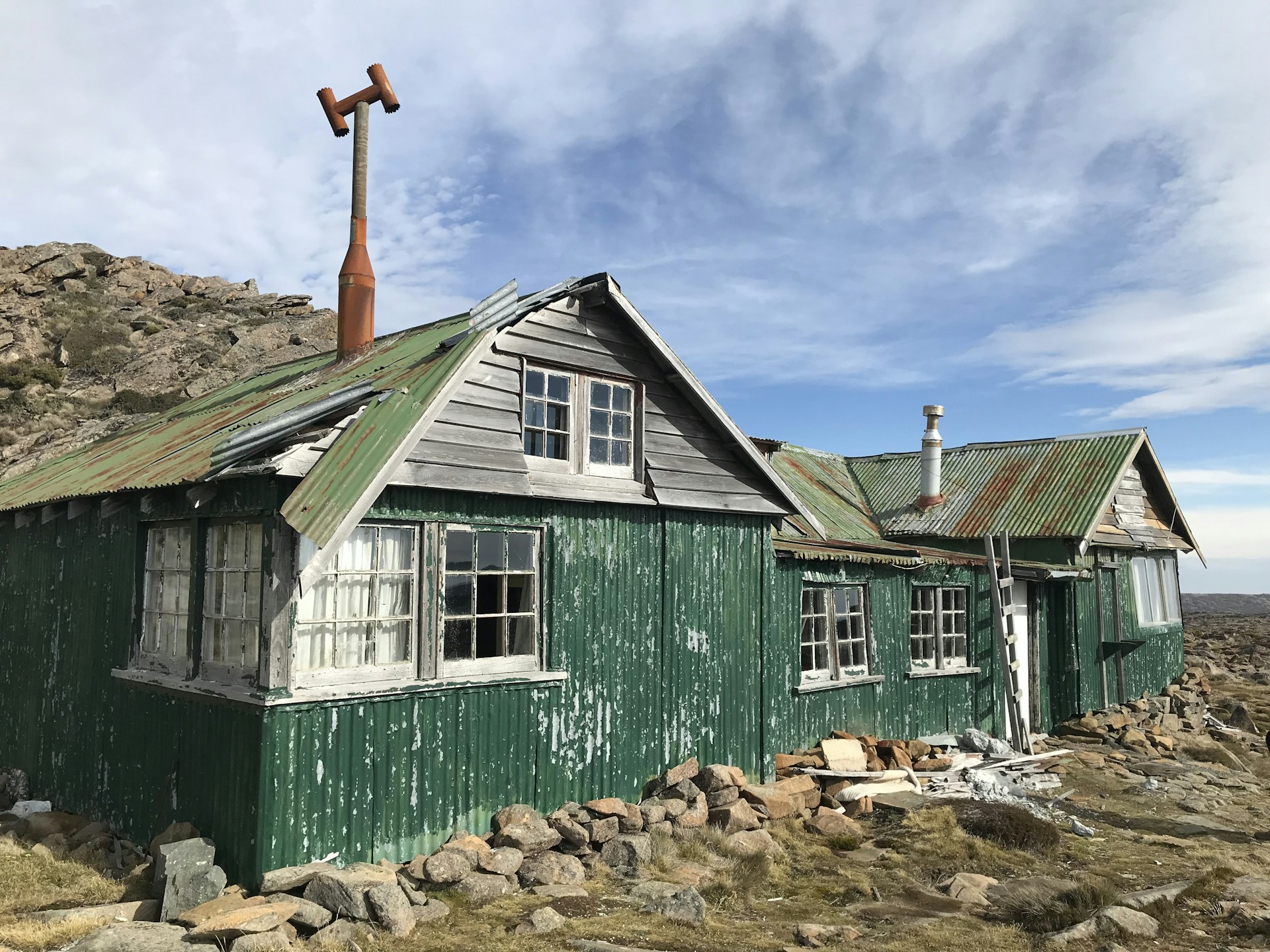 green and white wooden house under blue sky during daytime