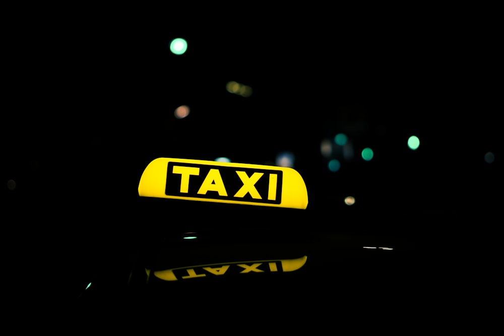 yellow and black taxi sign