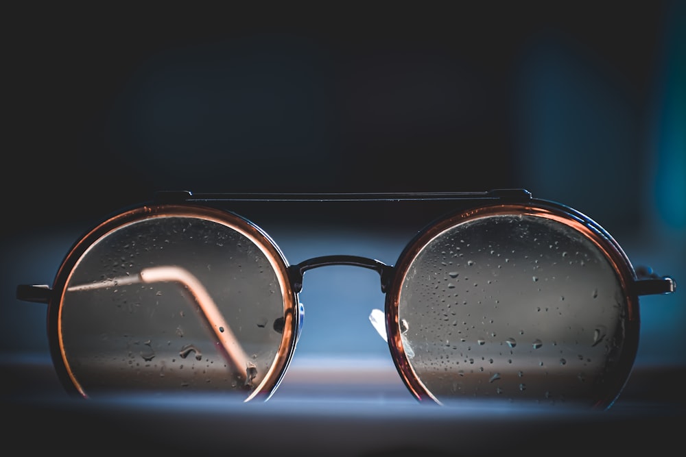 silver framed eyeglasses on black background