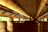 Close-up of a luxurious train interior with polished wood finishes and soft lighting.