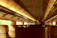 Close-up of a luxurious train interior with polished wood finishes and soft lighting.