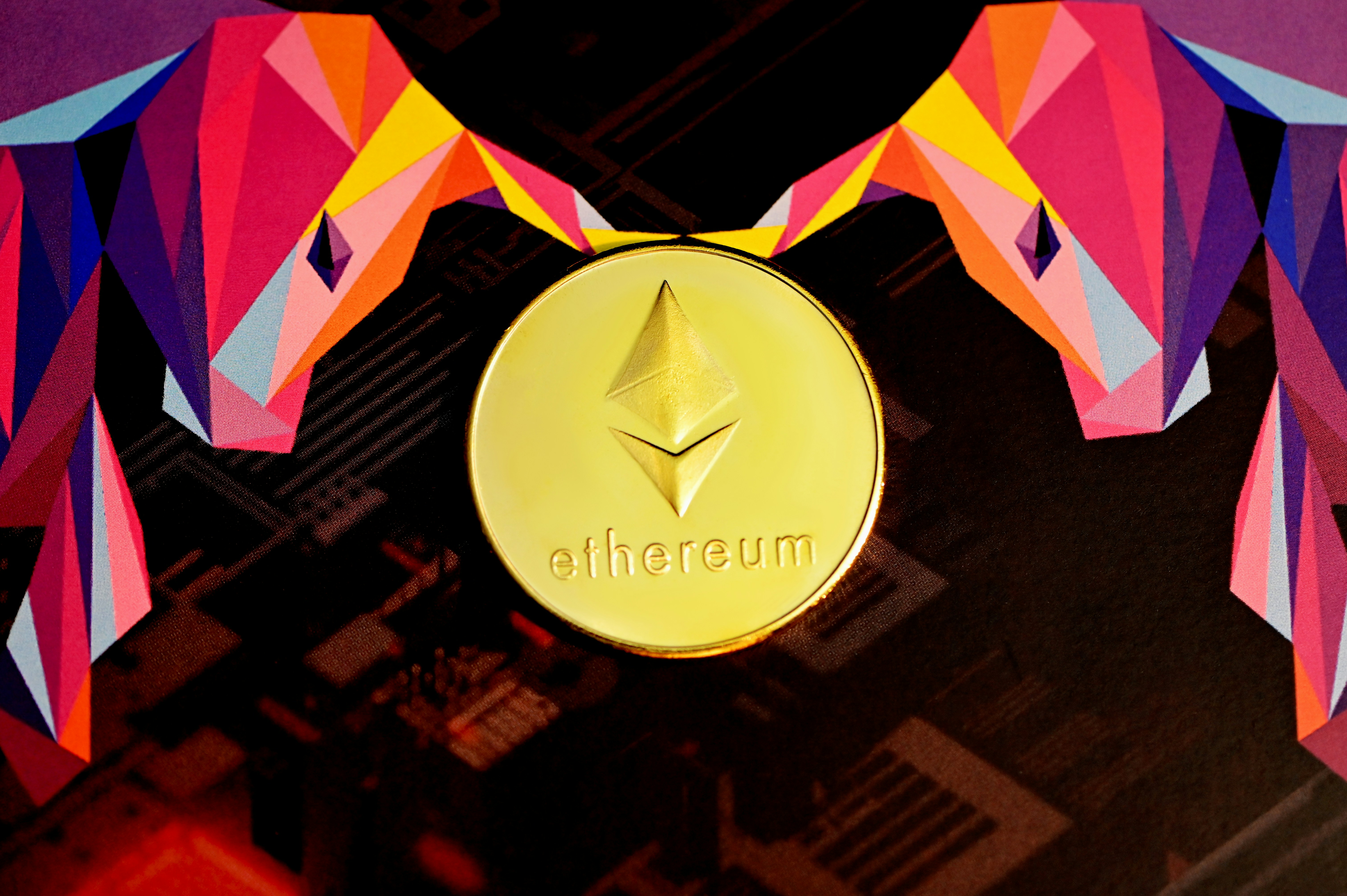 An Ethereum coin in between two executium bull logo.