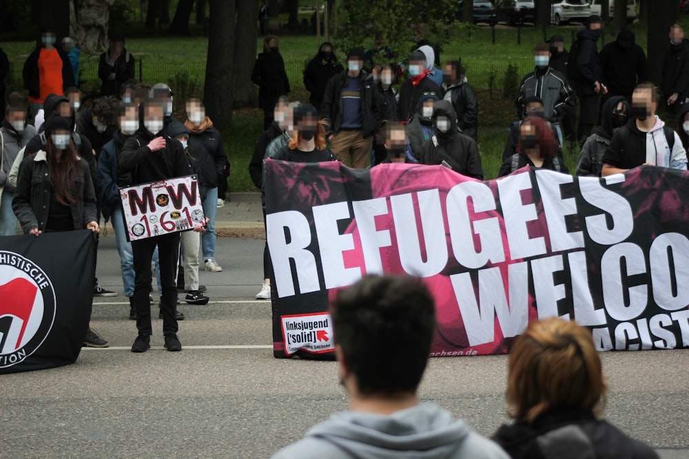 people holding purple and white banner