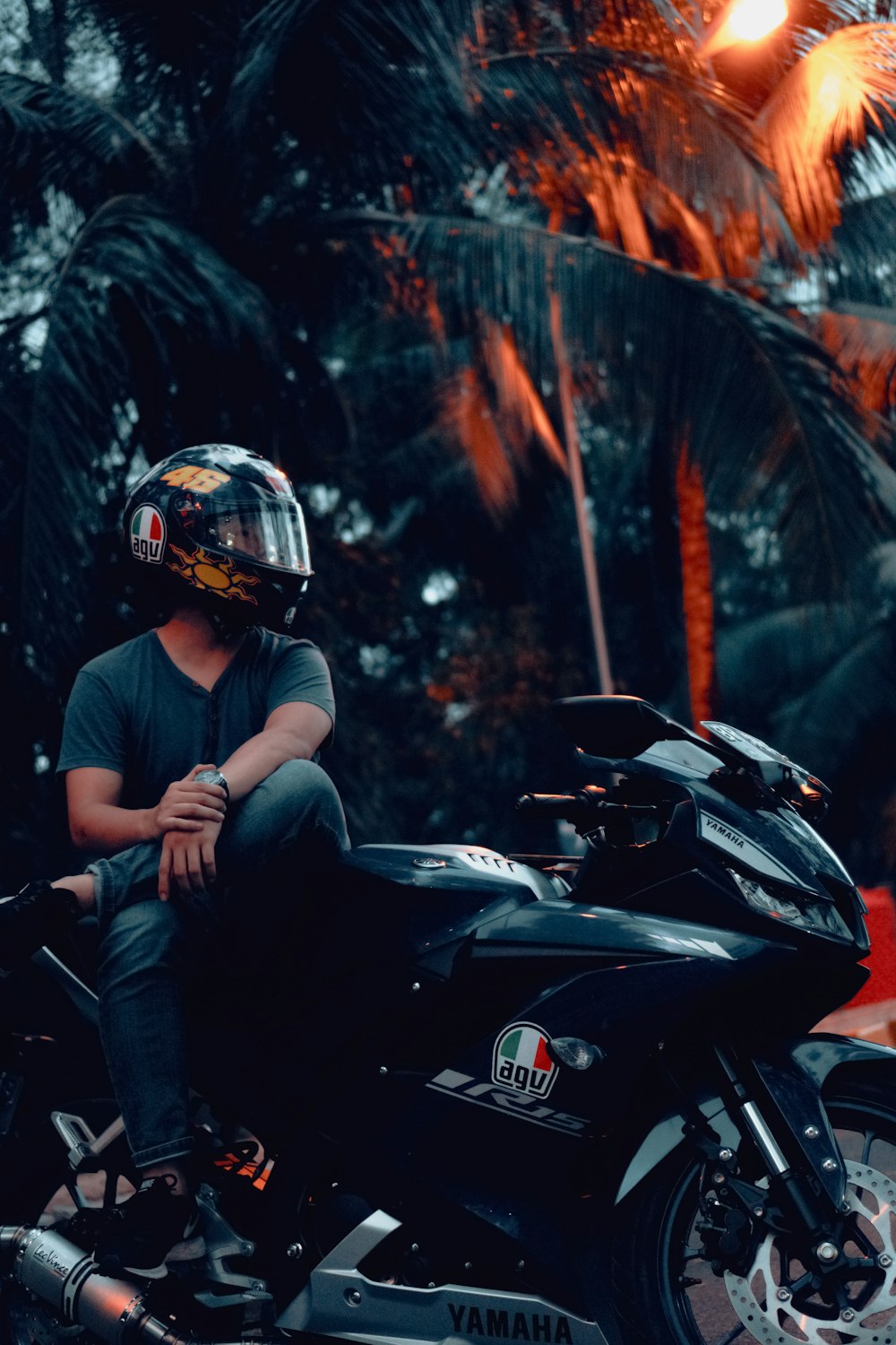 man in blue shirt riding black sports bike