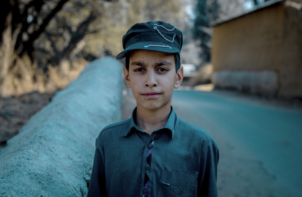 boy in blue button up shirt and blue cap