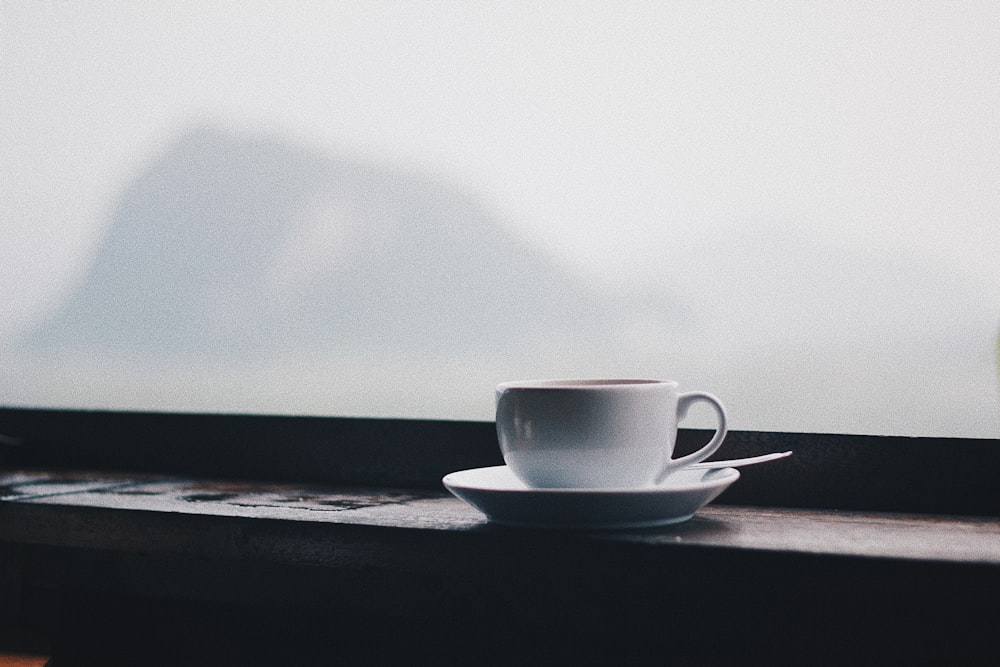 white ceramic teacup on saucer