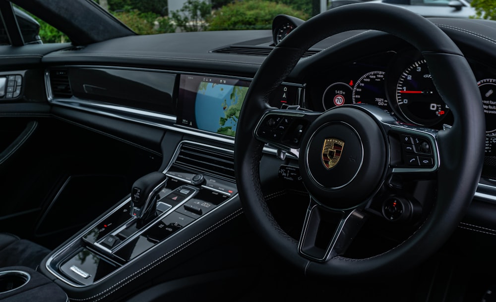 black car steering wheel during daytime