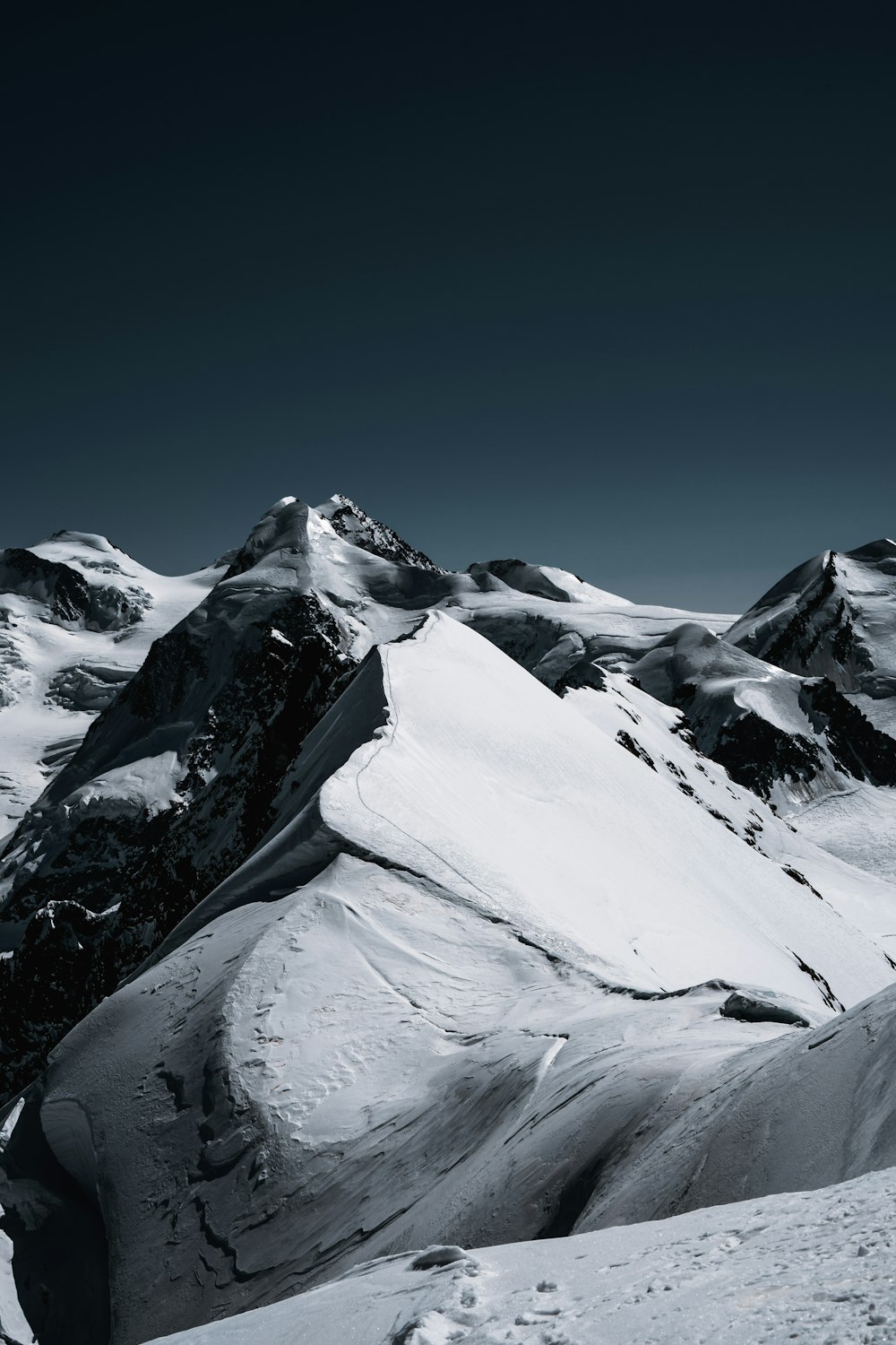 snow covered mountain under blue sky during daytime