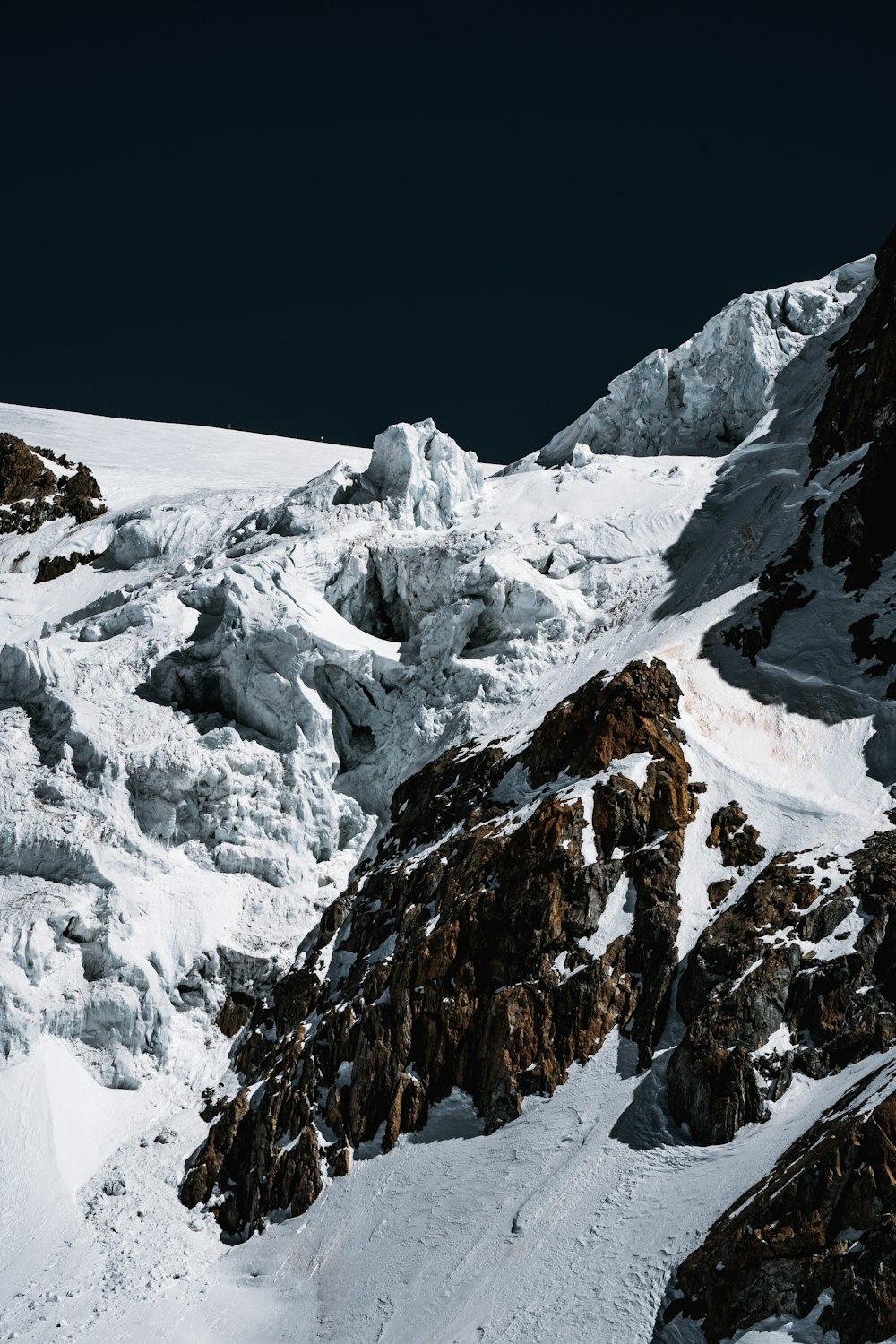 snow covered mountain during daytime