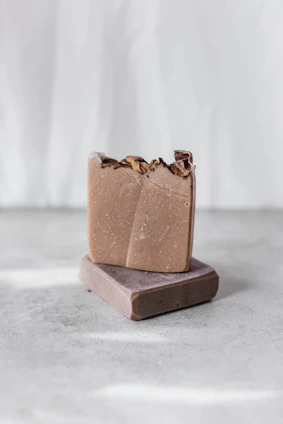 Minimalist soap bars with natural textures displayed on stone slabs