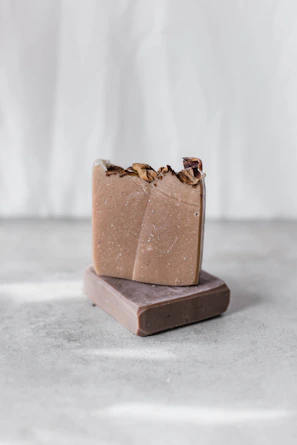 Artisan soap and liquid shampoo bars arranged on a rustic wooden surface.