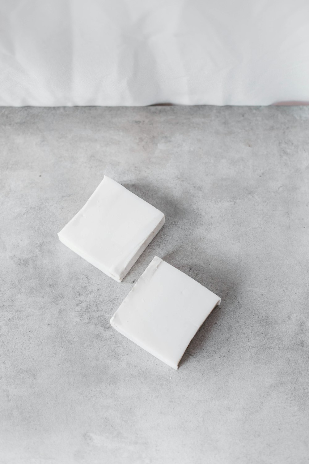 a couple of white square objects sitting on top of a cement floor