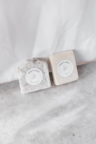 Elegant handmade soap bars with botanical textures on a natural linen cloth.