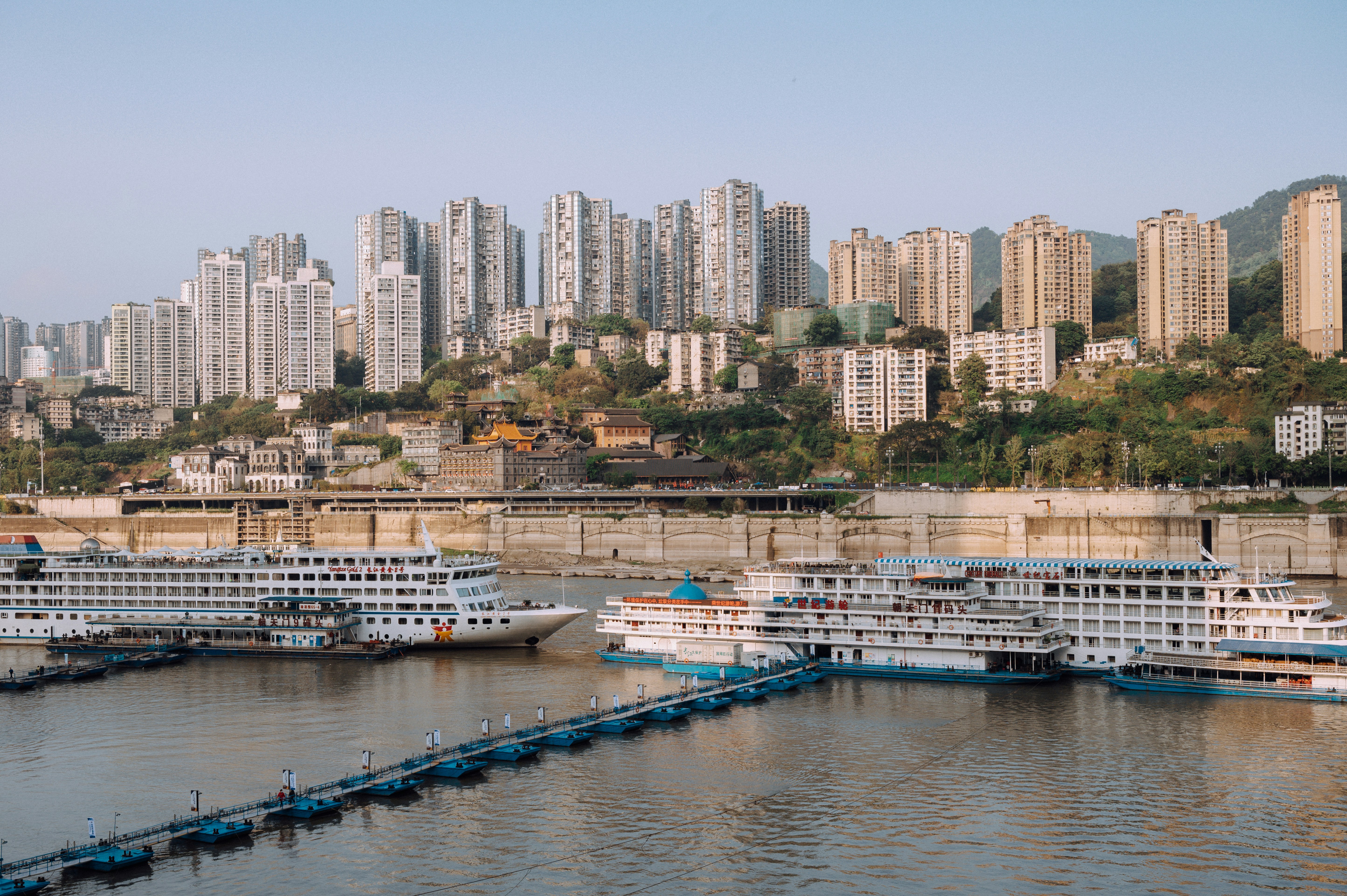 white and blue boat on body of water during daytime