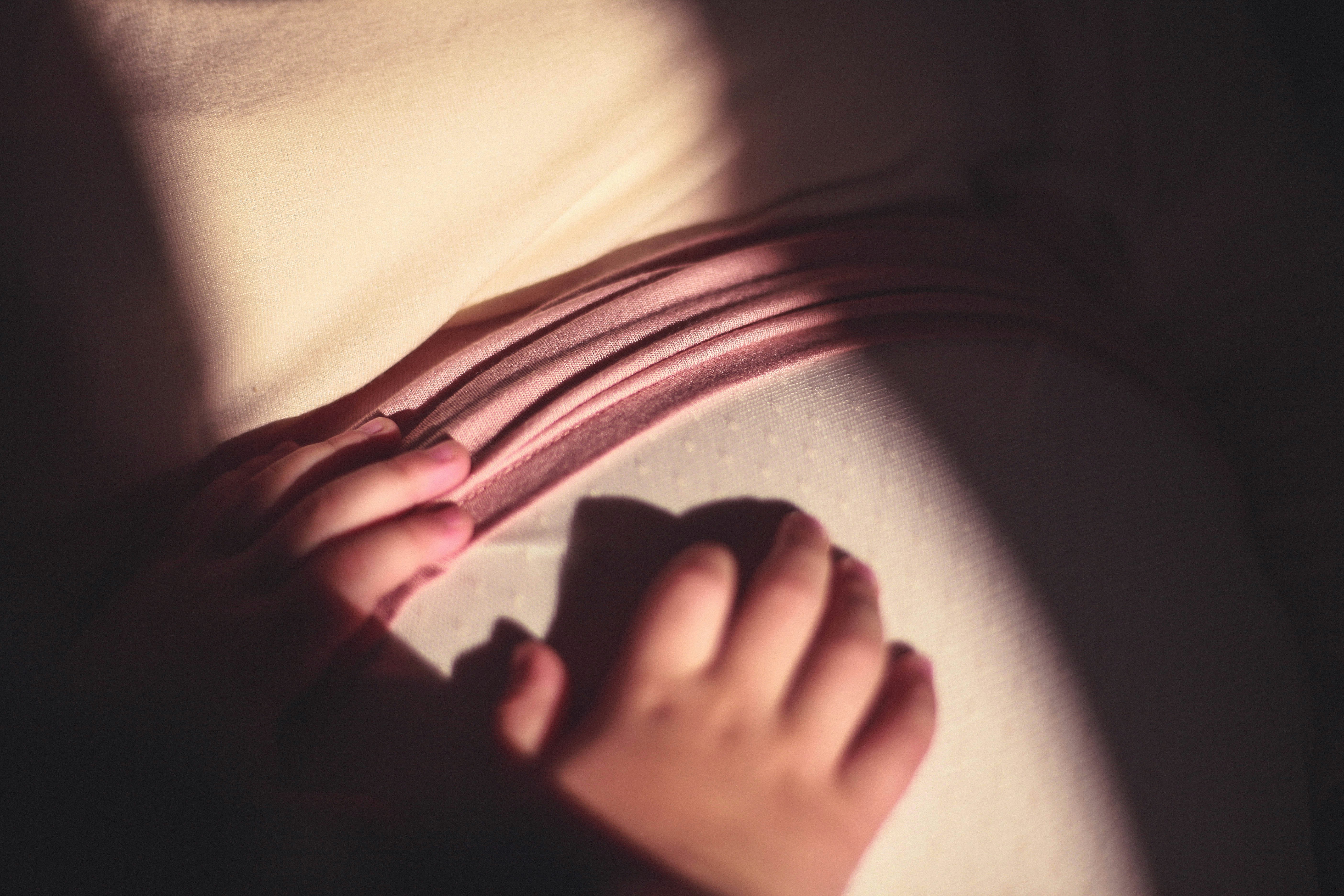 persons left foot on white textile