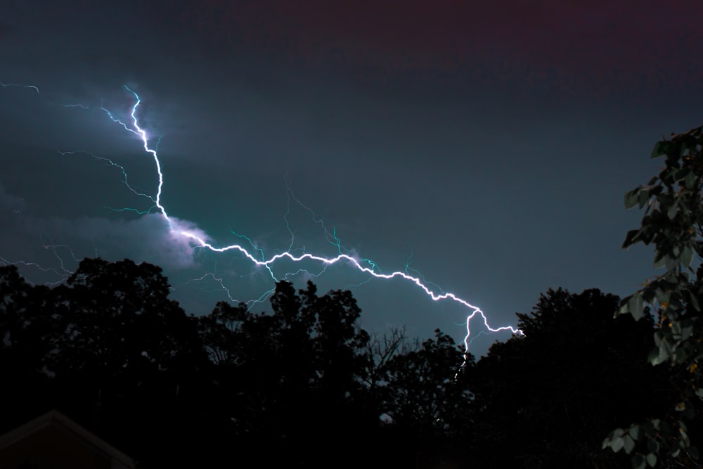 a lightning bolt hitting through the night sky