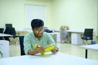 man in green long sleeve shirt holding yellow banana