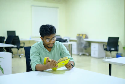 man in green long sleeve shirt holding yellow banana