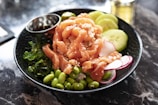 A delicious poke bowl garnished with fresh ingredients.