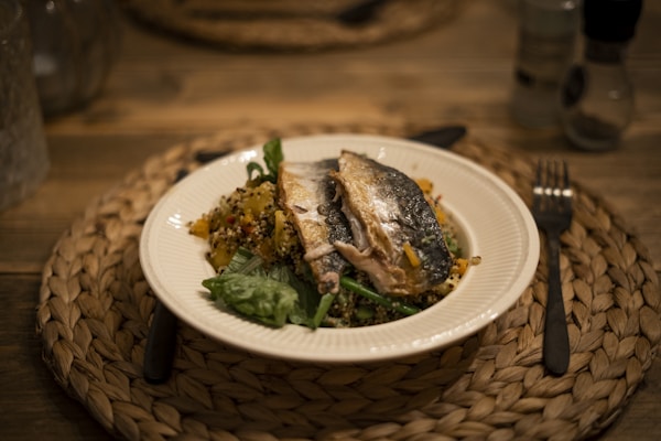Cooked fish on white ceramic plate
