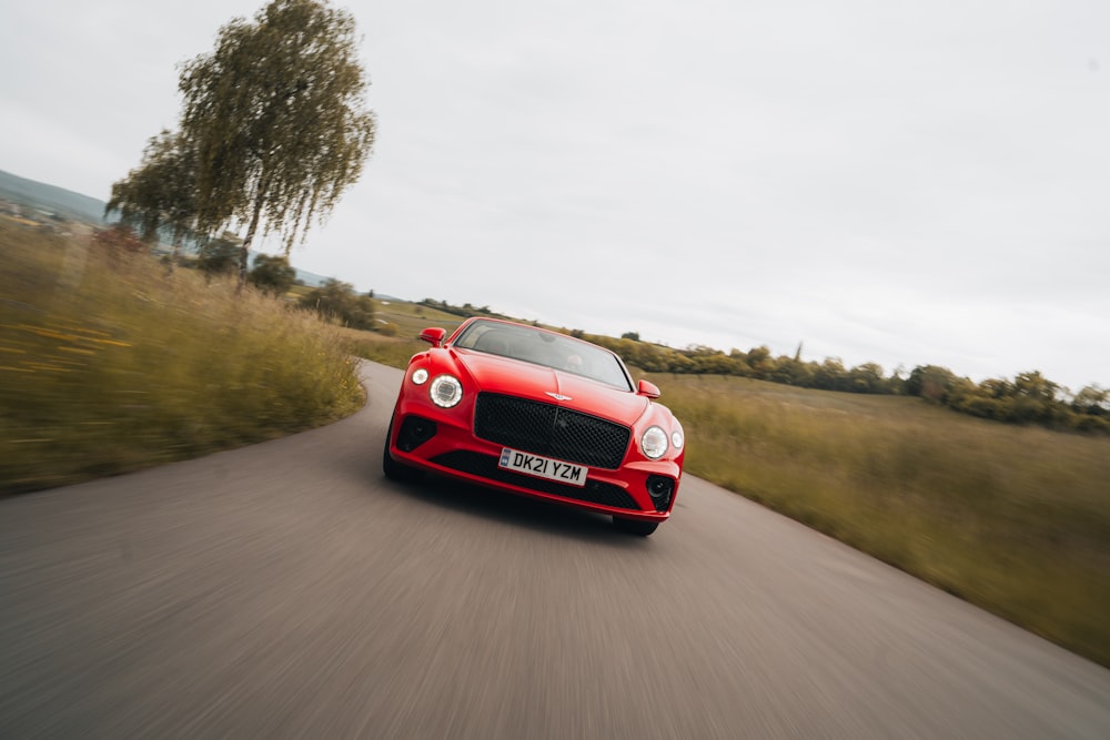 red car on road during daytime