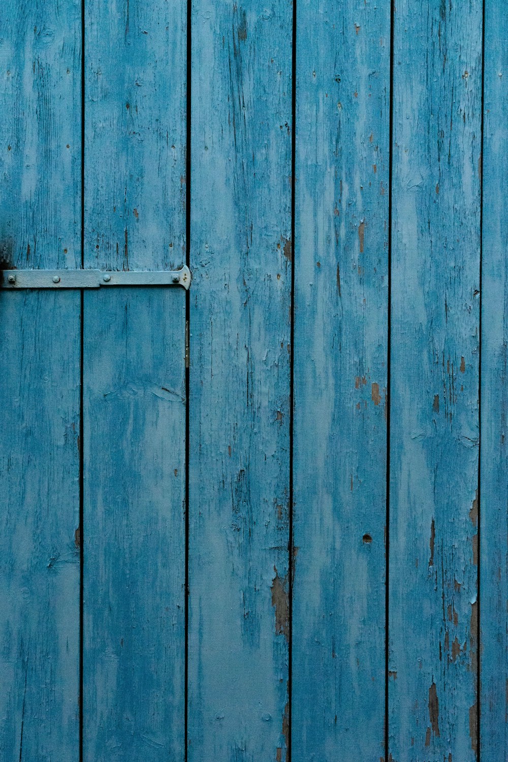 blue wooden door with white metal door handle