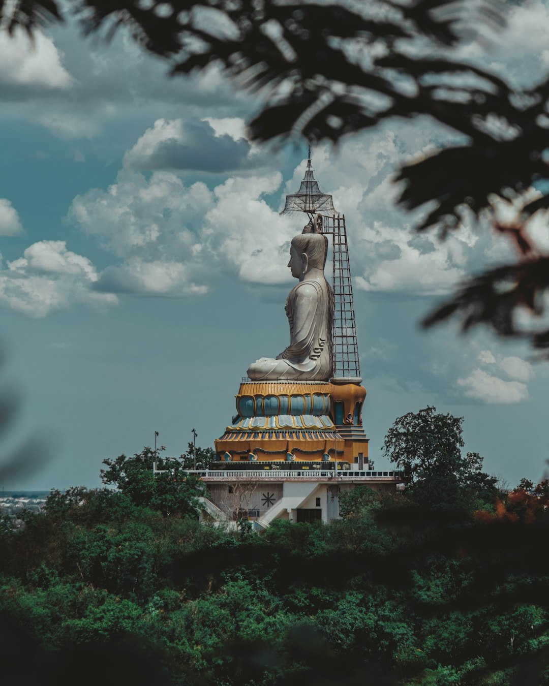 white and gold buddha statue under cloudy sky during daytime