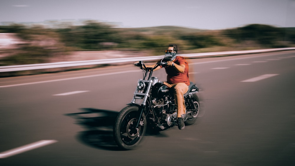 man riding motorcycle on road during daytime