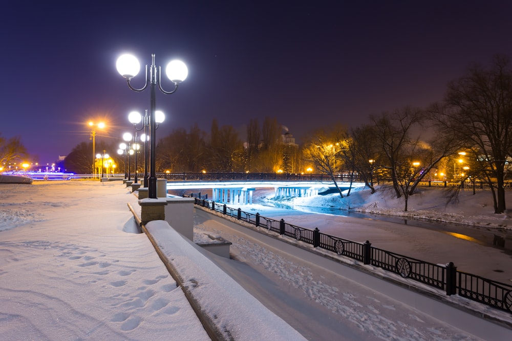 snow covered road during night time