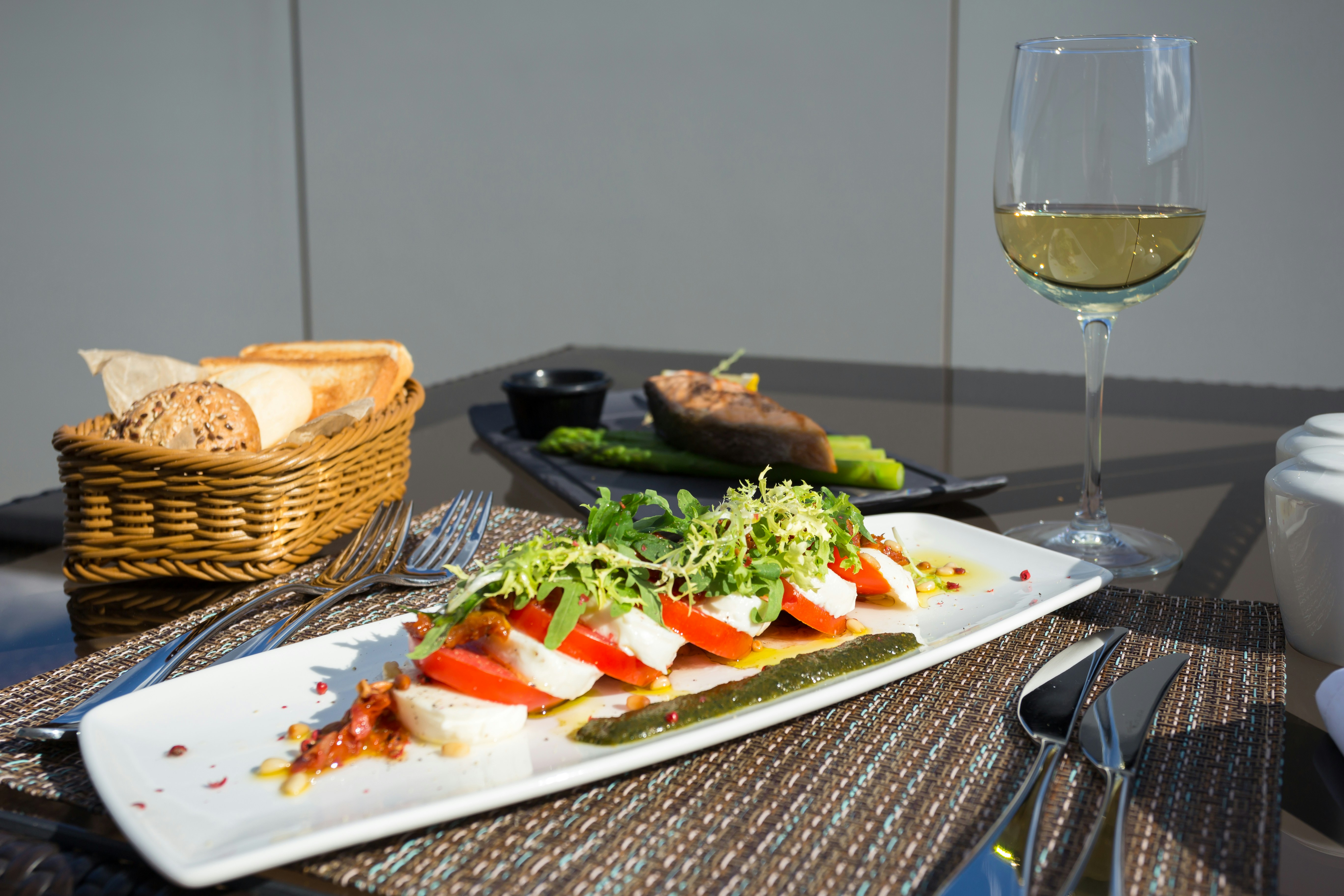 vegetable salad on white ceramic plate, Light sunny breakfast on the veranda of the Hilton