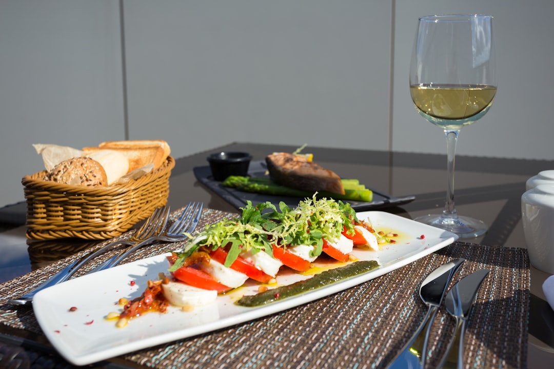 vegetable salad on white ceramic plate, Light sunny breakfast on the veranda of the Hilton