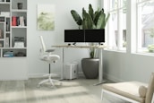 A calm and organized office space with ergonomic furniture and plants.