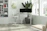 A modern office desk with ergonomic chair bathed in natural light.