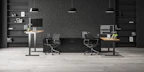 A comfortable office chair with adjustable features next to a workstation.